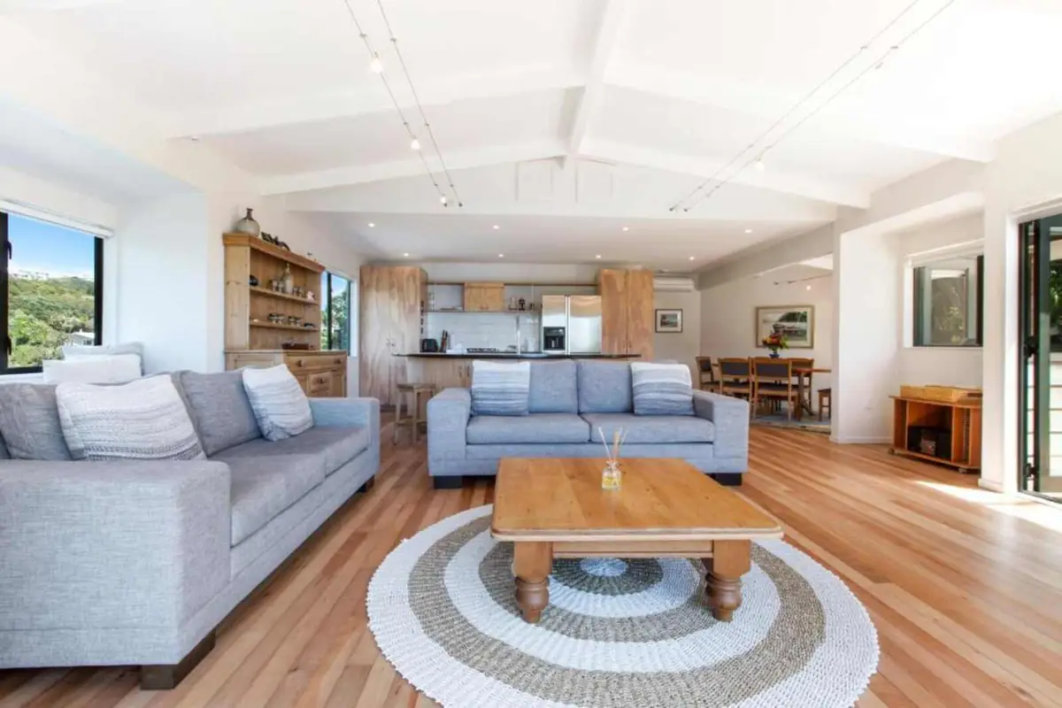 Open plan living room with wooden floors at the Waiheke Island holiday home