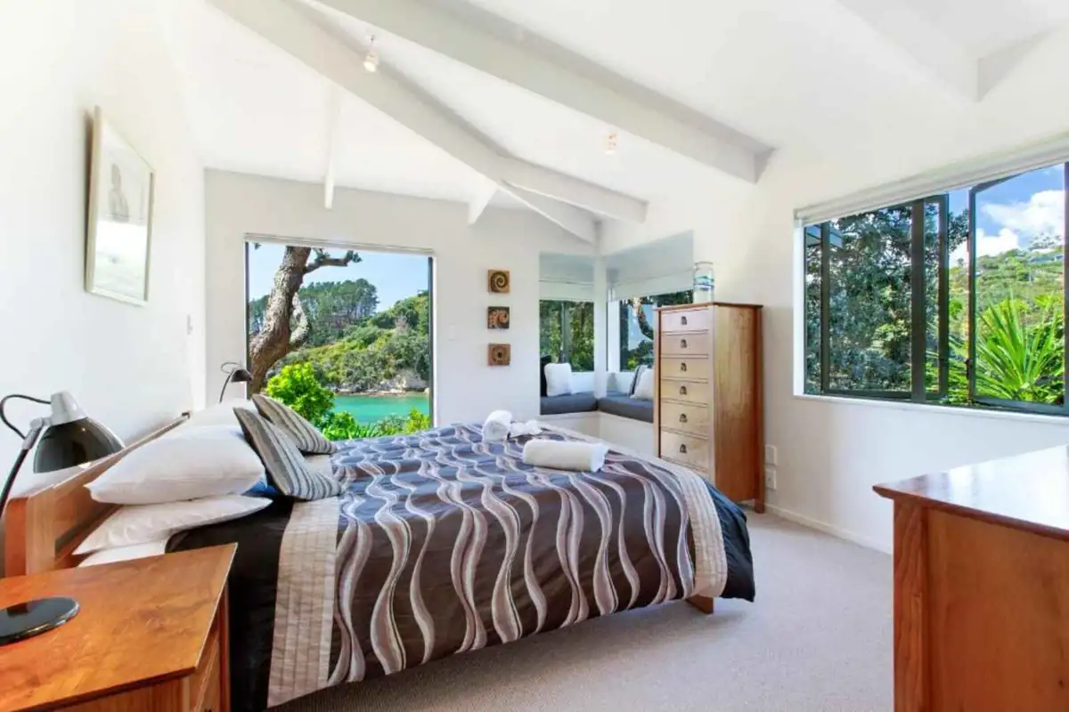 Bedroom with vaulted ceiling and bay views